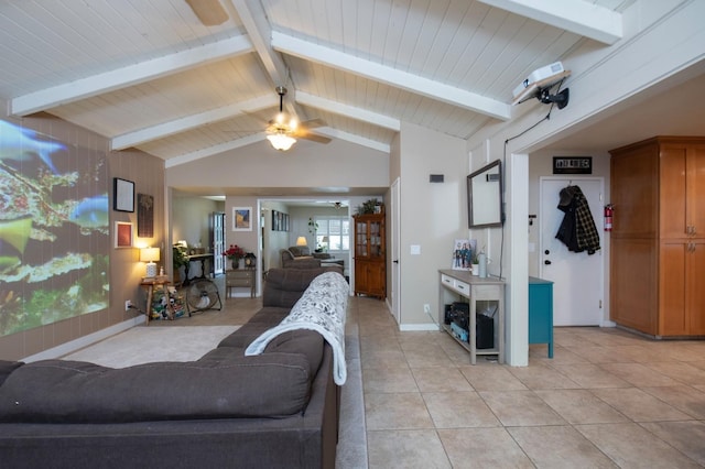 living room featuring lofted ceiling with beams, baseboards, a ceiling fan, and light tile patterned flooring