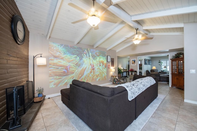 living room featuring a large fireplace, vaulted ceiling with beams, baseboards, and light tile patterned floors