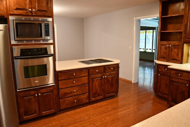 kitchen with dark hardwood / wood-style flooring and stainless steel appliances