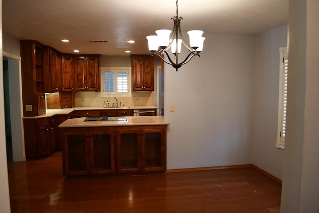 kitchen with dark wood-type flooring, tasteful backsplash, black electric cooktop, sink, and an inviting chandelier