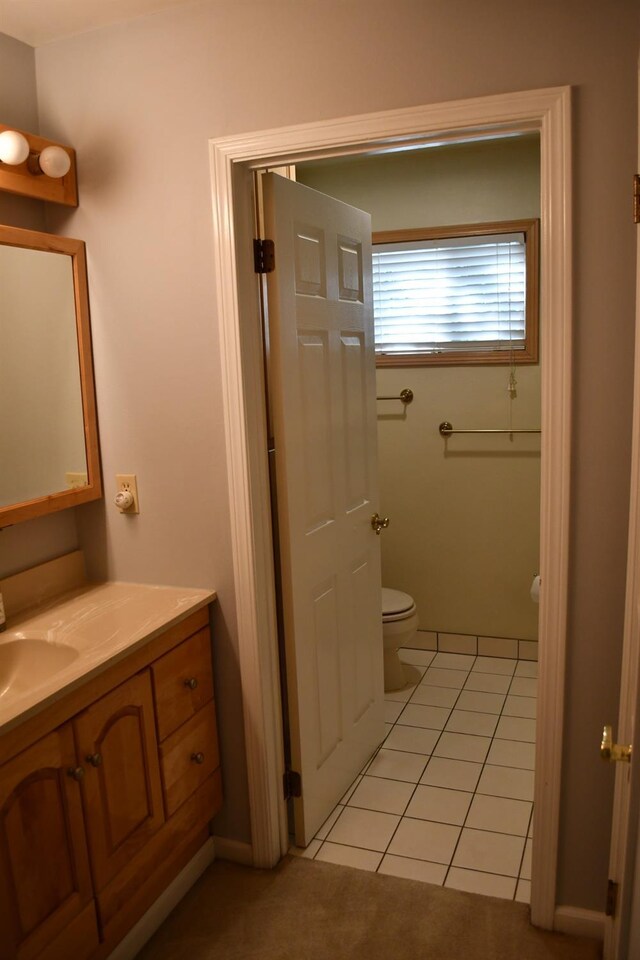 bathroom with tile patterned floors, vanity, and toilet