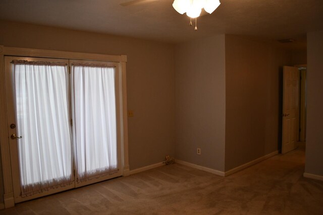 carpeted empty room with ceiling fan