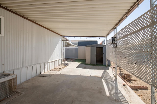 view of patio with central air condition unit, a storage unit, and an outdoor structure