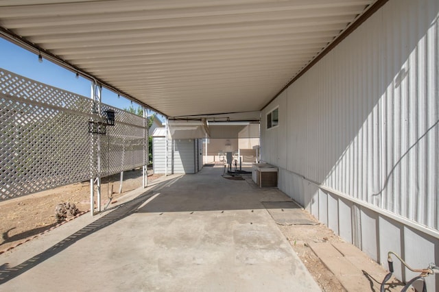 view of patio with an outbuilding and an attached carport