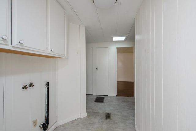 washroom with cabinet space, visible vents, and light wood-type flooring