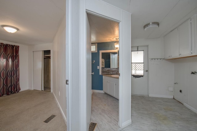 interior space featuring visible vents, vanity, and baseboards