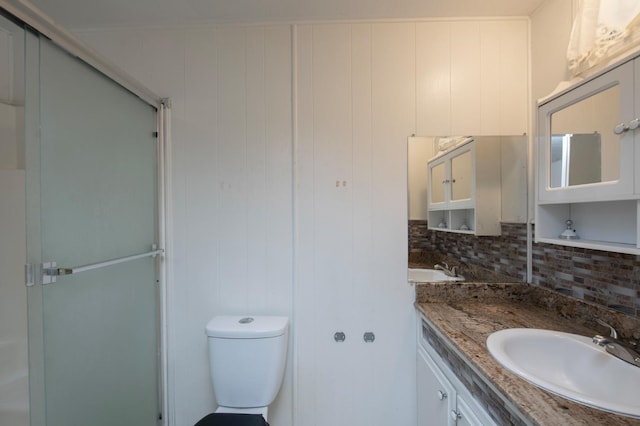 full bath featuring backsplash, a stall shower, vanity, and toilet