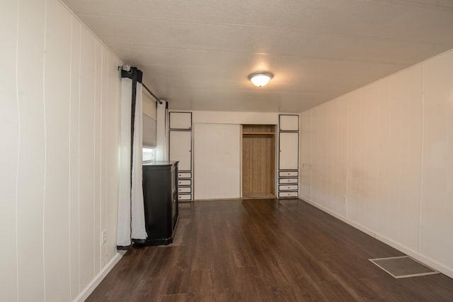 interior space featuring dark wood-style floors and visible vents