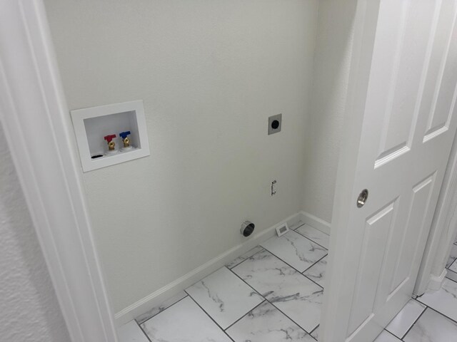 laundry room featuring hookup for a washing machine, light tile patterned floors, and hookup for an electric dryer