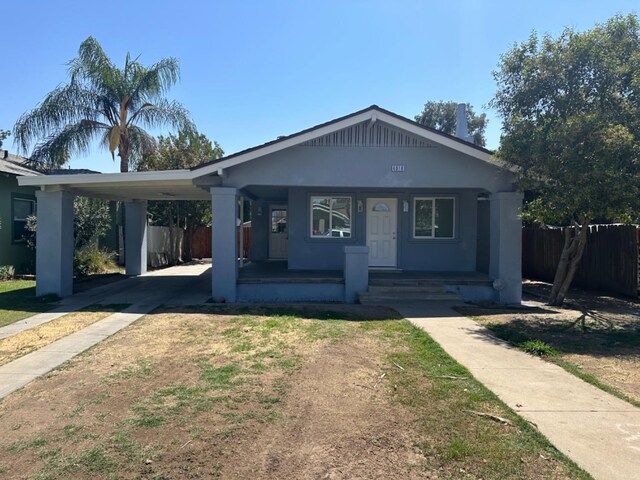 view of front of home with a porch and a carport