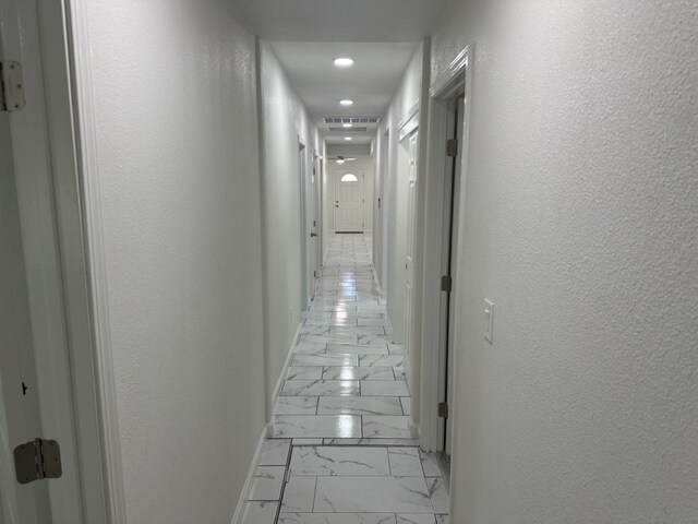 corridor with light tile patterned floors