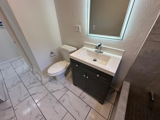 bathroom featuring tile patterned flooring, vanity, and toilet