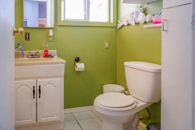 bathroom with vanity, toilet, and tile patterned floors