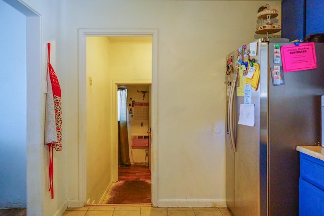 hall featuring light tile patterned flooring