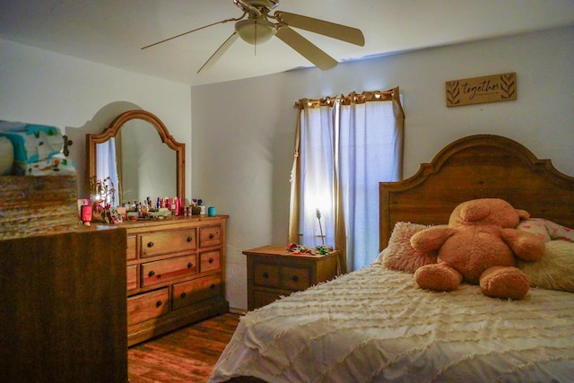 bedroom featuring multiple windows, dark hardwood / wood-style flooring, and ceiling fan