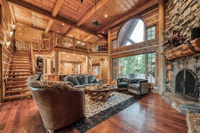 living room with a fireplace, wood ceiling, dark hardwood / wood-style flooring, and high vaulted ceiling