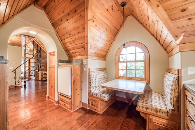 interior space featuring high vaulted ceiling, beamed ceiling, wood-type flooring, and wooden ceiling