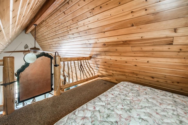 carpeted bedroom featuring wooden ceiling and beamed ceiling