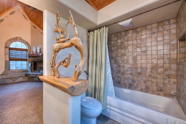 bathroom with toilet, shower / tub combo, and a stone fireplace