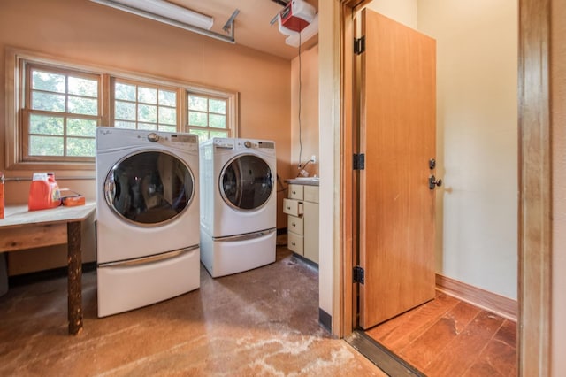 laundry room with hardwood / wood-style flooring and washer and clothes dryer