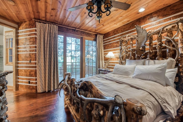 bedroom with ceiling fan, rustic walls, wood-type flooring, and wooden ceiling