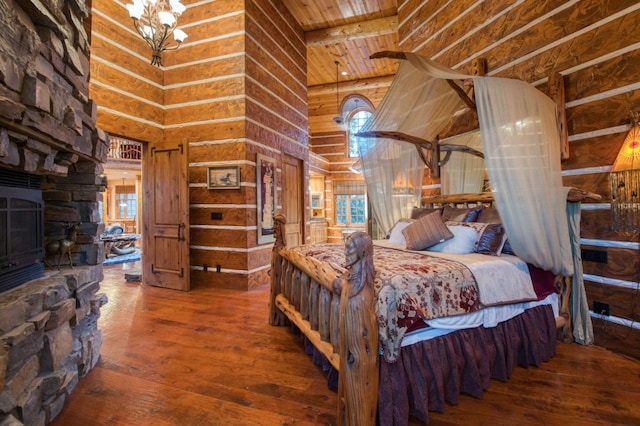 bedroom with wooden ceiling, high vaulted ceiling, hardwood / wood-style flooring, and rustic walls