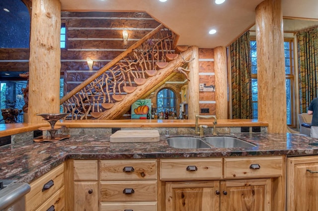 kitchen featuring dark stone counters and sink