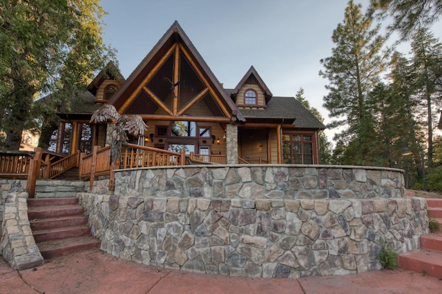 log-style house featuring a wooden deck