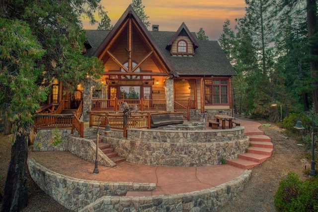 view of back house at dusk