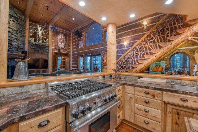 kitchen with high end stainless steel range oven, beamed ceiling, light brown cabinetry, hardwood / wood-style floors, and wood ceiling