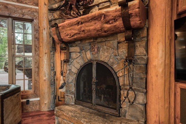 interior details with wood-type flooring and a fireplace