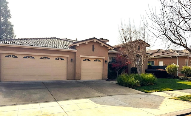 mediterranean / spanish-style house with a garage