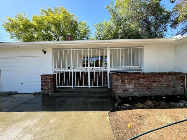 doorway to property with a garage