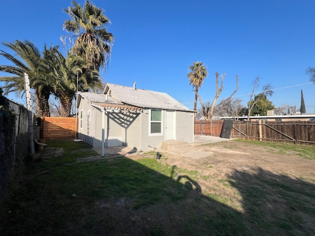 rear view of house with a lawn