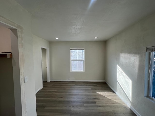 unfurnished room featuring dark wood-type flooring