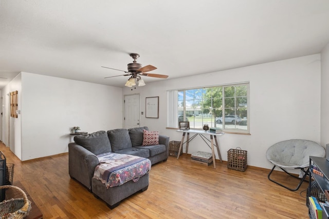 living room featuring ceiling fan and hardwood / wood-style flooring