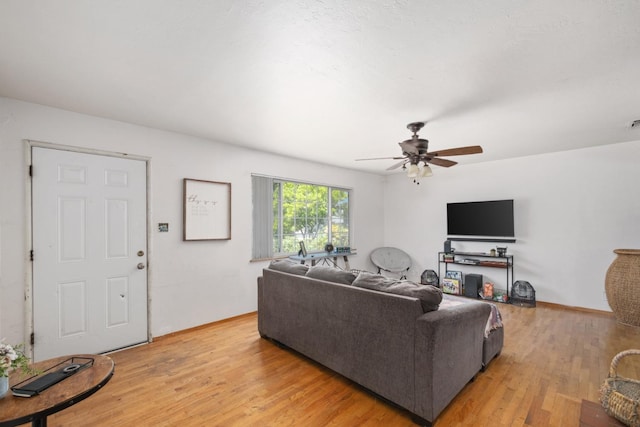 living room featuring ceiling fan and light hardwood / wood-style floors