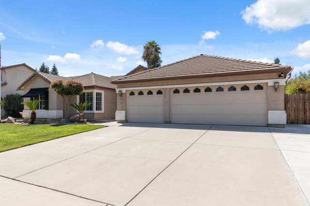 ranch-style home with a garage and a front lawn