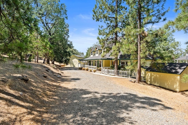 exterior space with covered porch and an outdoor structure