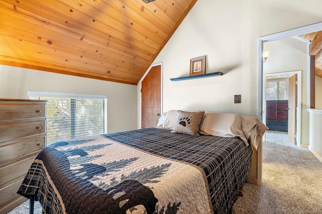 bedroom featuring multiple windows, vaulted ceiling, and carpet floors