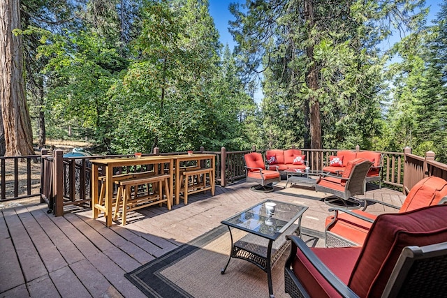 wooden terrace with an outdoor hangout area