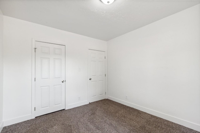 unfurnished bedroom with a closet and carpet floors