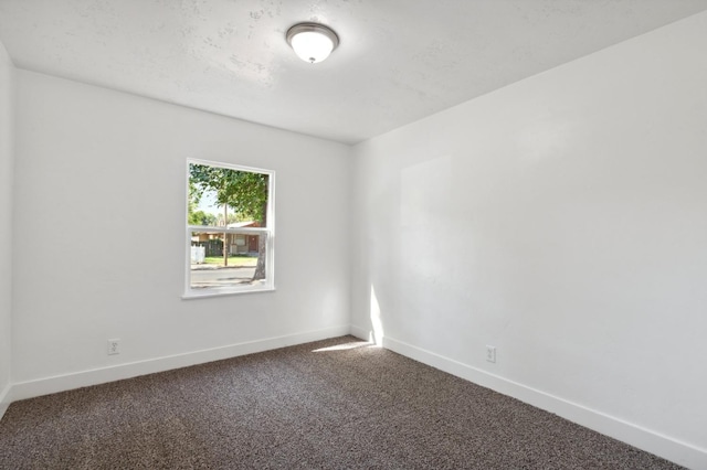 carpeted empty room with baseboards