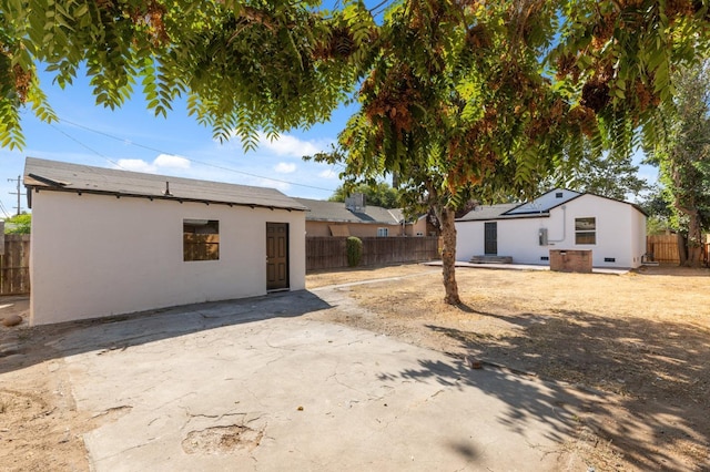 rear view of property with fence and stucco siding