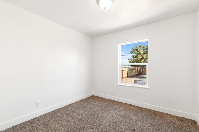 empty room with carpet and baseboards