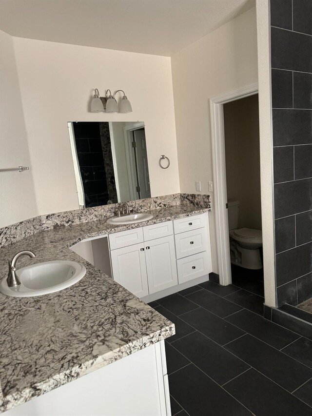 bathroom featuring tile patterned floors, toilet, and vanity