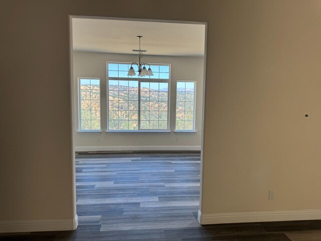 interior space featuring dark hardwood / wood-style flooring and a chandelier