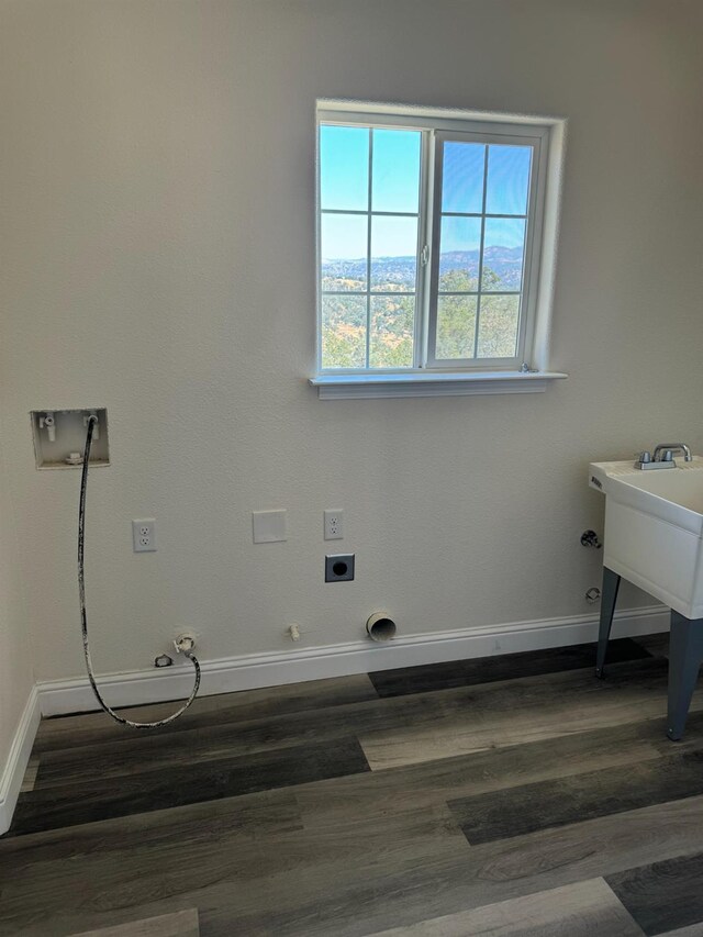 clothes washing area featuring washer hookup, hookup for an electric dryer, dark hardwood / wood-style floors, and hookup for a gas dryer