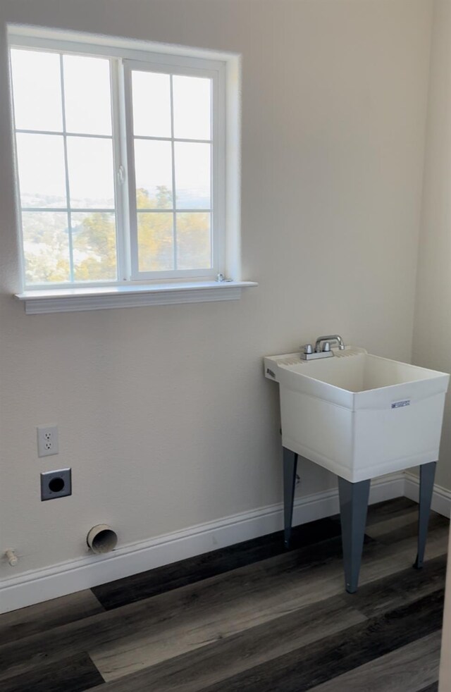 washroom with dark hardwood / wood-style flooring and electric dryer hookup