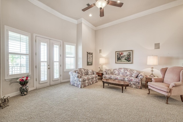 living room featuring a high ceiling, carpet, french doors, crown molding, and ceiling fan